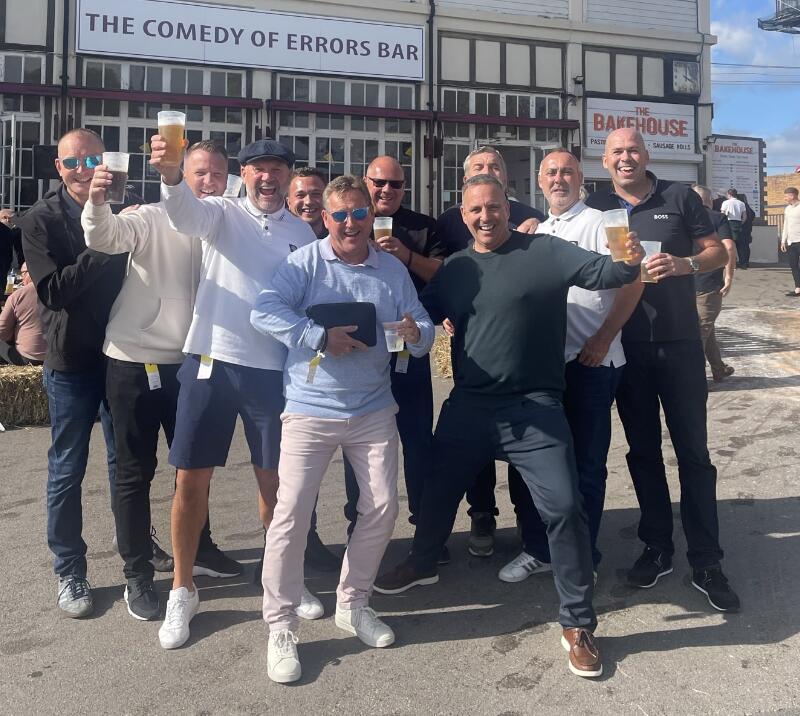 A large group of guys getting ready to go into Fontwell Races
