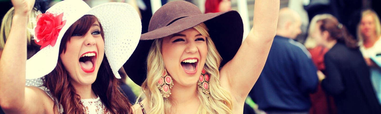Two ladies cheering while at the races at Fontwell Park Racecourse.